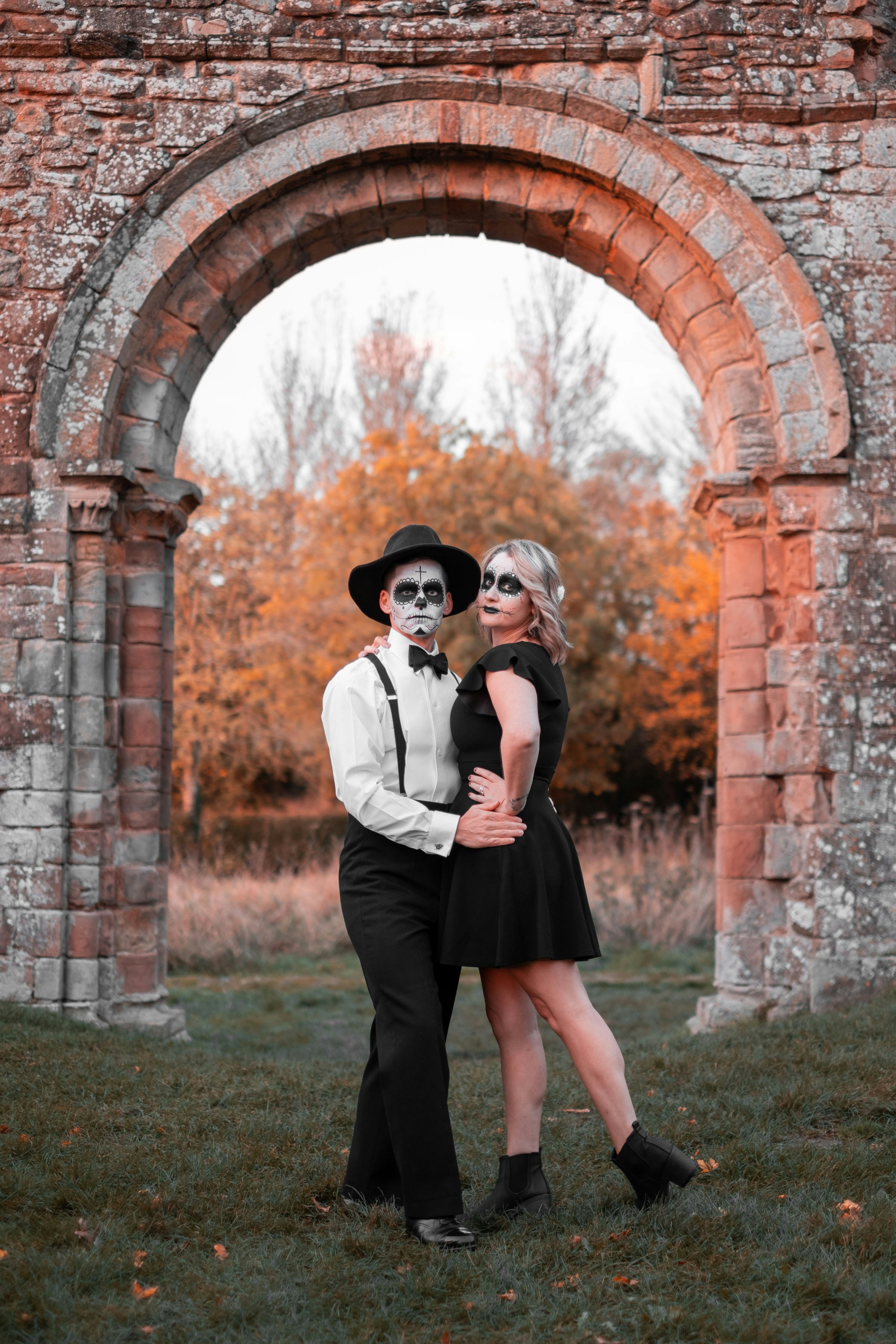 a couple of people that are standing in the grass