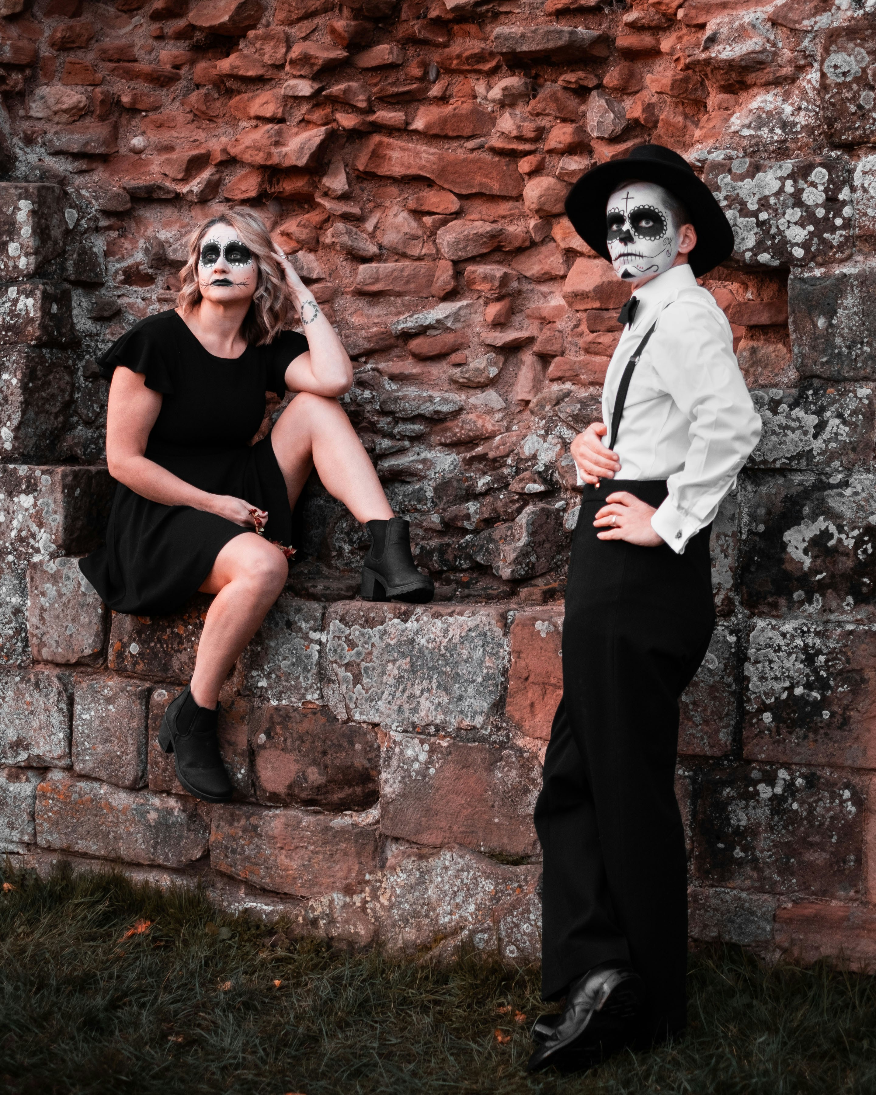 a couple of people that are sitting on a wall