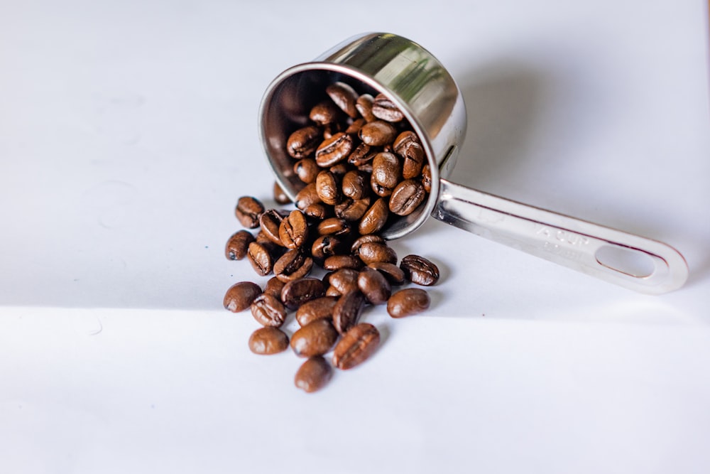 coffee beans spilling out of a coffee cup