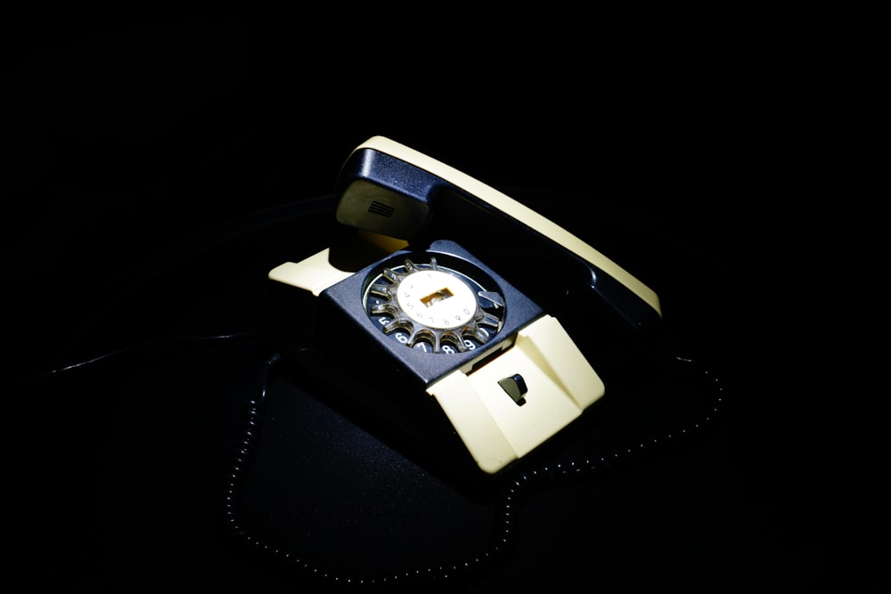 a black and yellow phone on a black surface