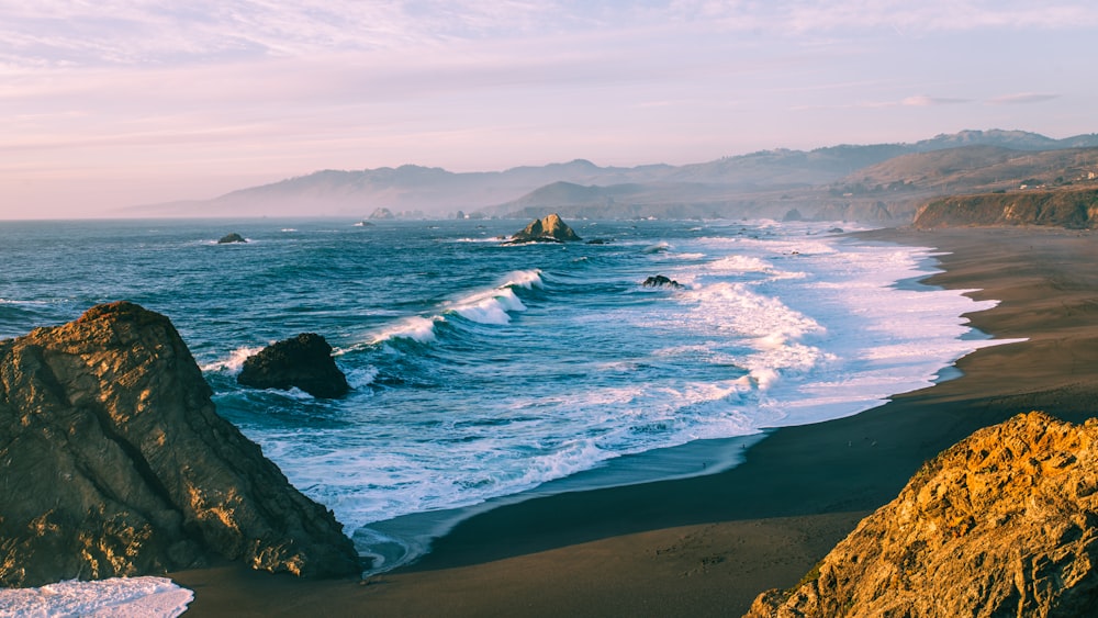 a view of the ocean from a rocky cliff