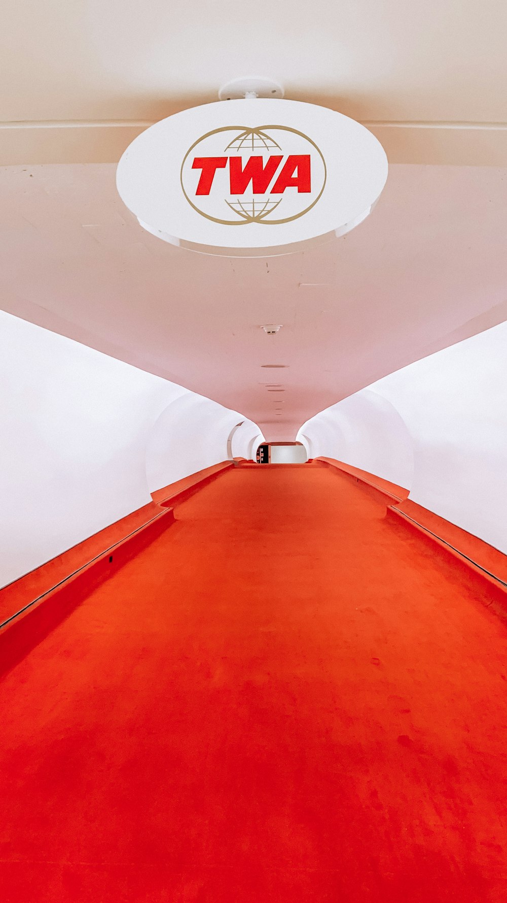 a red carpeted hallway with a awt logo on the ceiling