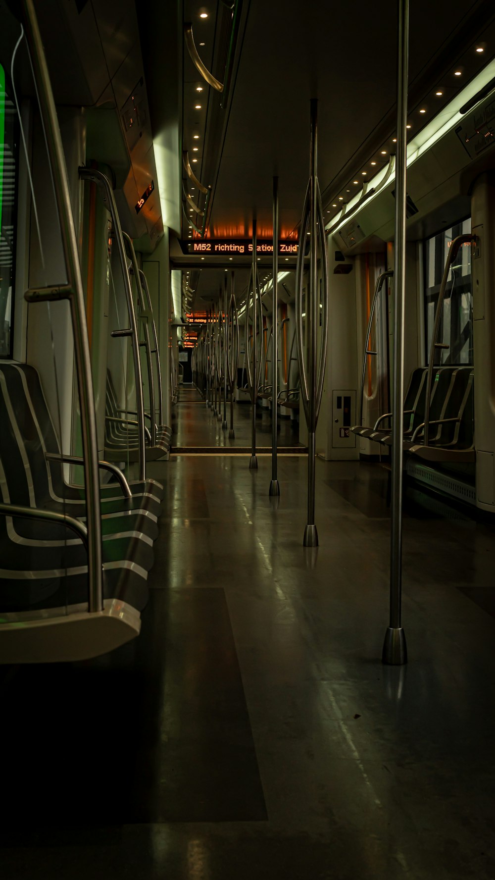 a dimly lit subway car with empty seats
