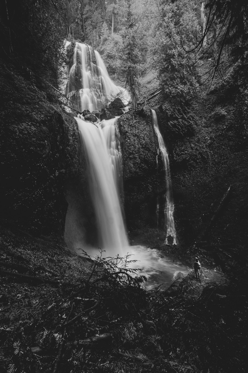 a black and white photo of a waterfall