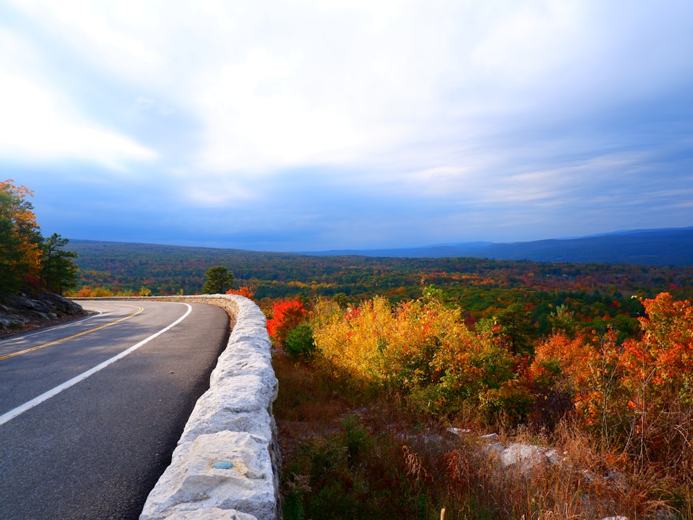 a long stone wall on the side of a road