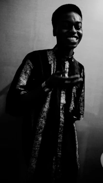 A warm, inviting photo of a person smiling thoughtfully while holding a phone, symbolizing hope and connection.