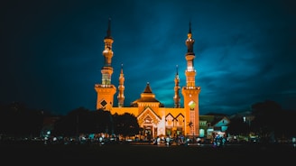 a large building with two towers lit up at night