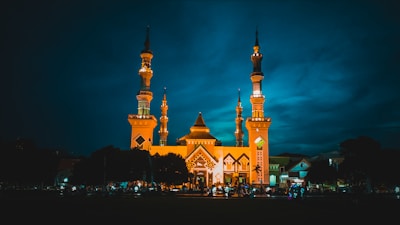 a large building with two towers lit up at night