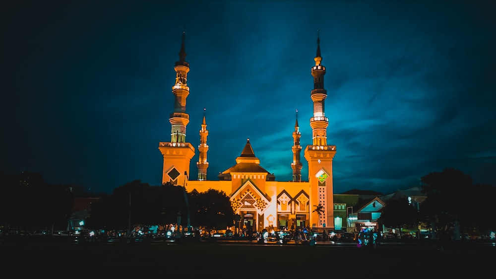 a large building with two towers lit up at night