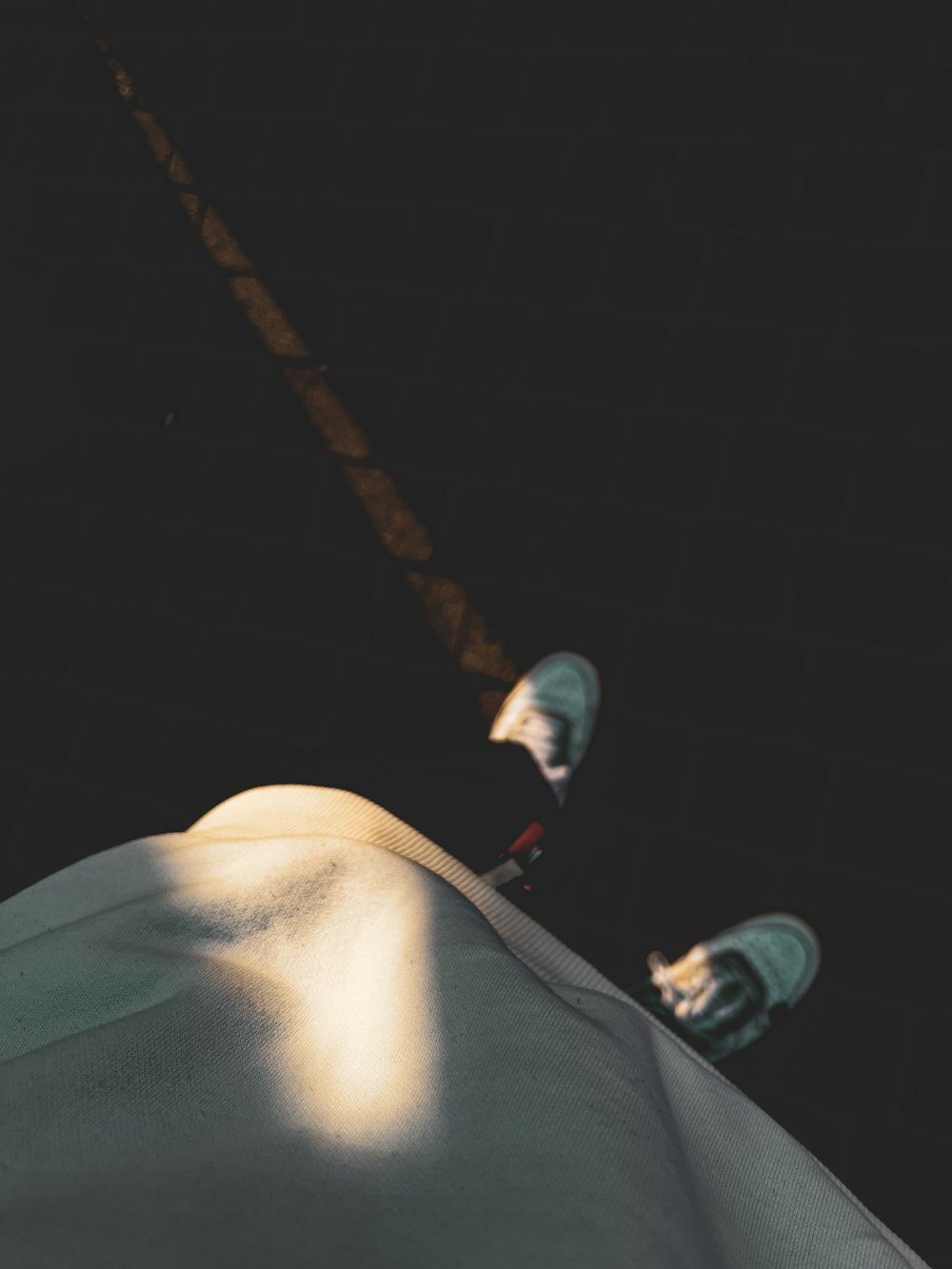 a person is snowboarding down a hill at night