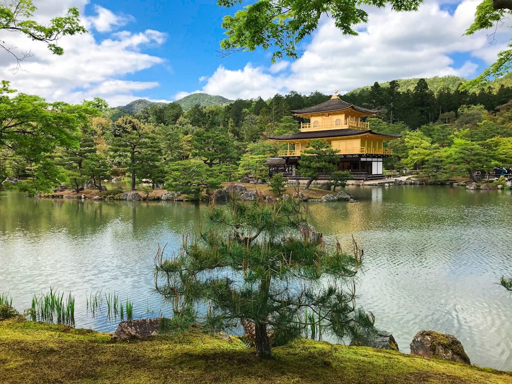 a small building sitting on top of a lush green hillside