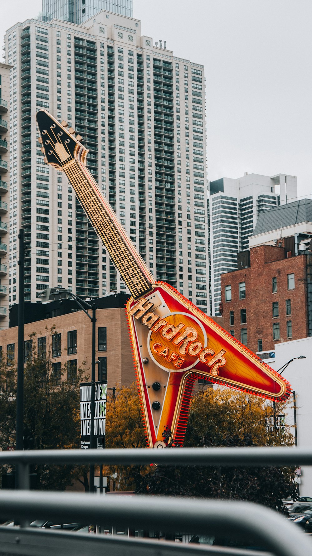 a guitar shaped sign in the middle of a city