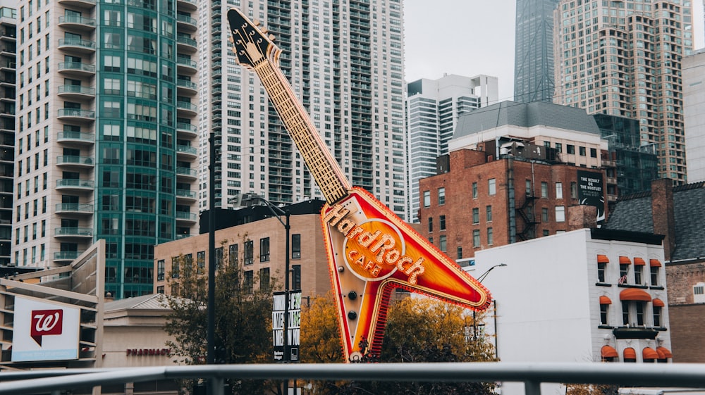 Un panneau en forme de guitare au milieu d’une ville