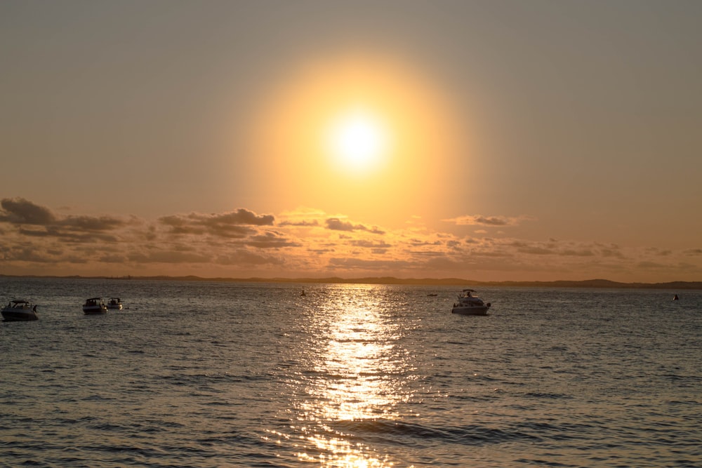 a group of boats floating on top of a large body of water