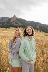 a man and a woman standing in a field