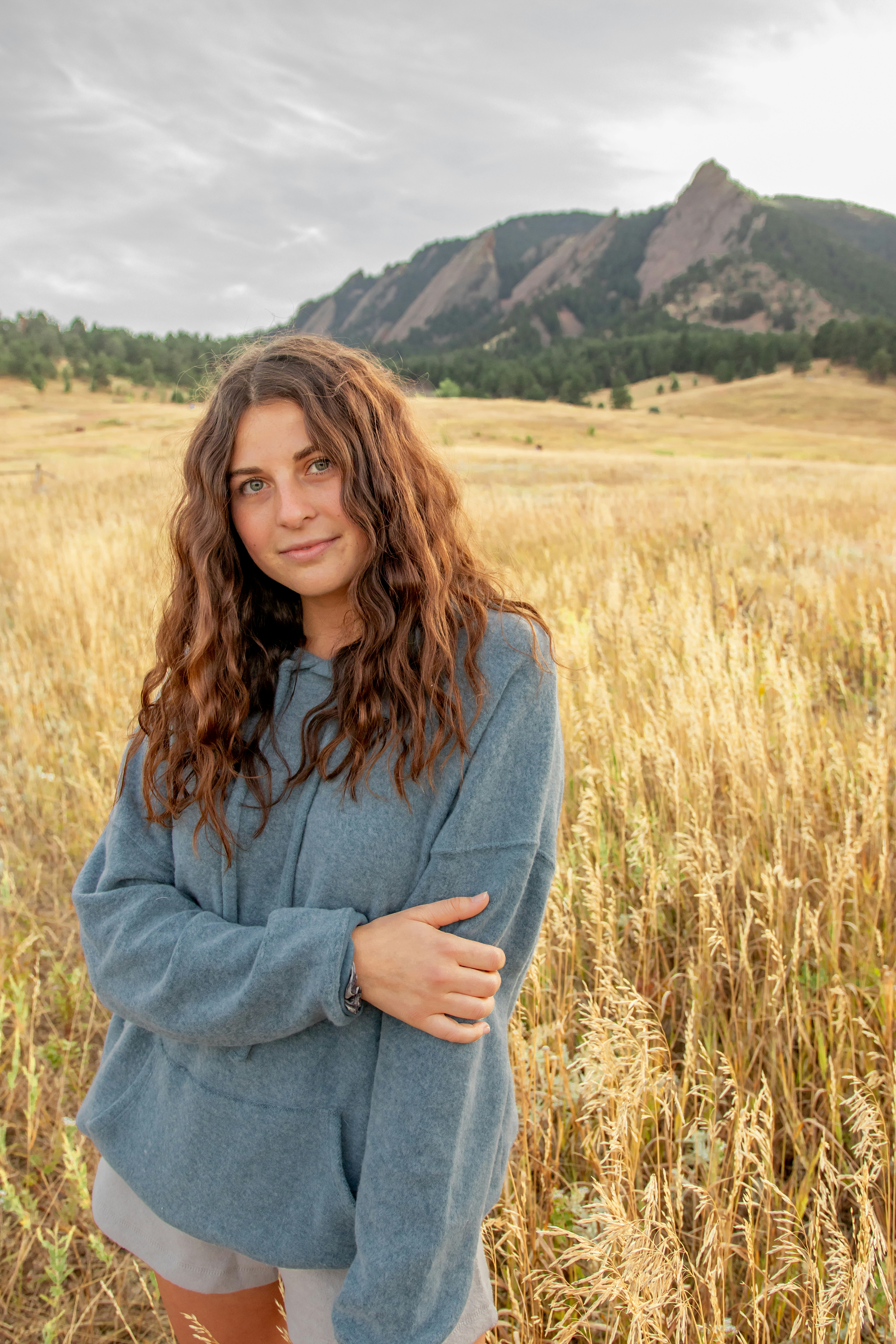 a woman standing in a field of tall grass