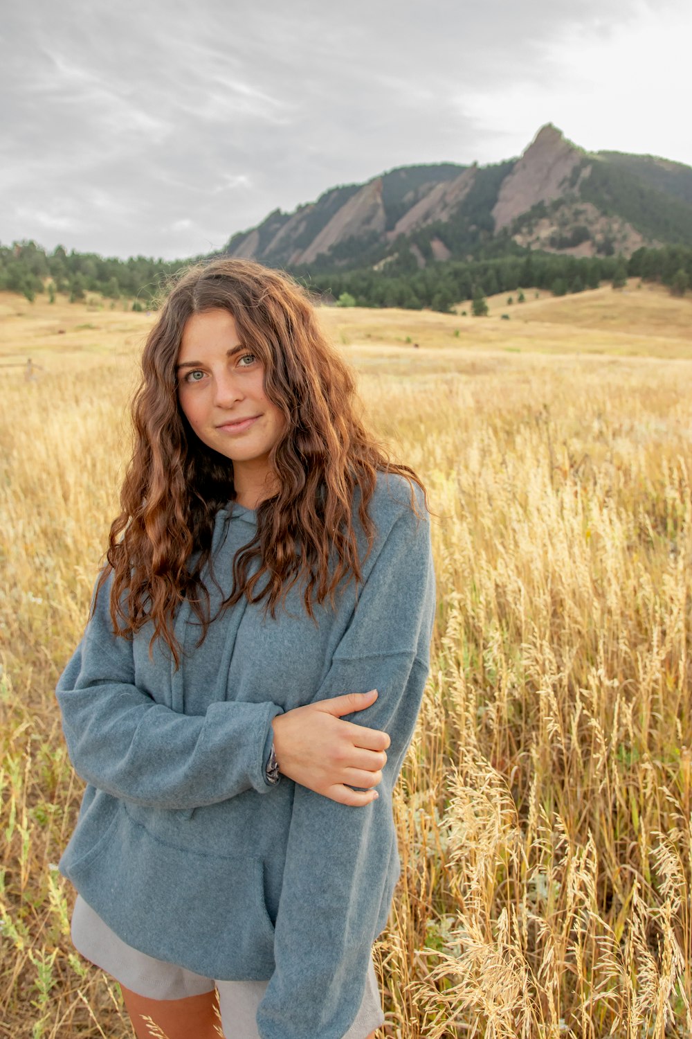 a woman standing in a field of tall grass