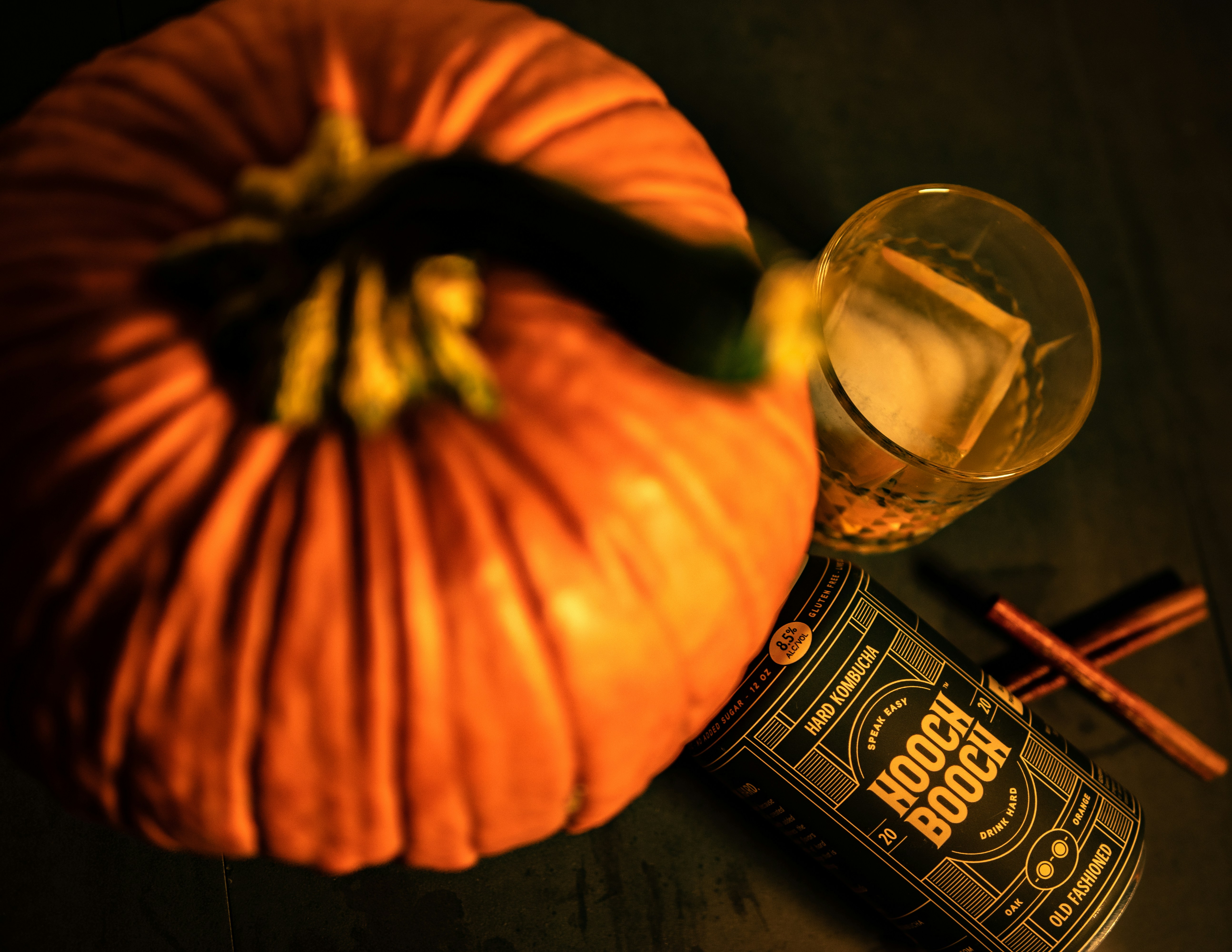 a bottle of booze next to a pumpkin