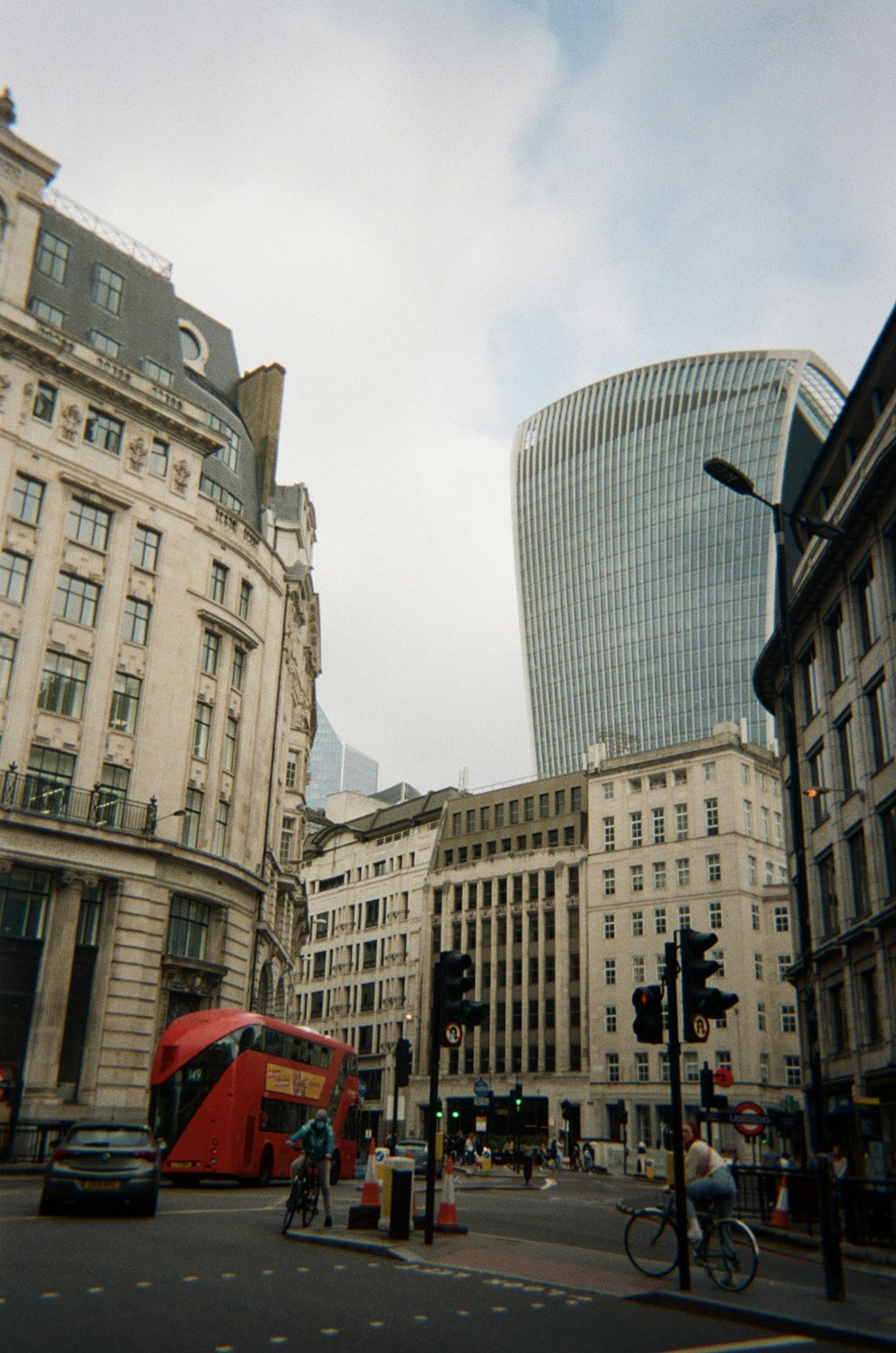 a red double decker bus driving down a street