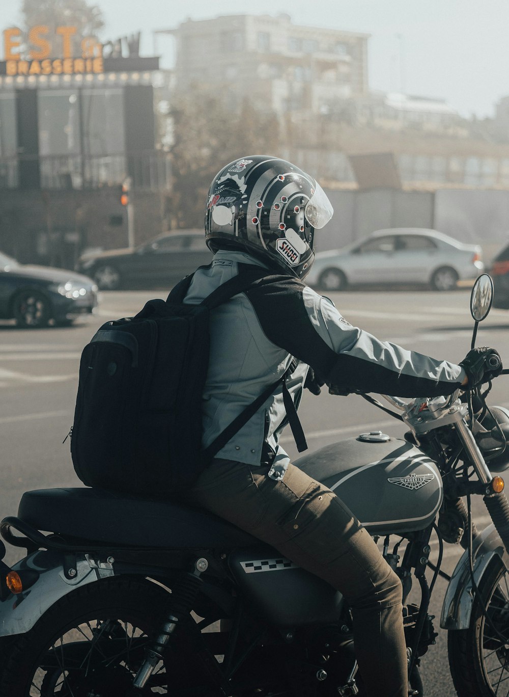 a man riding a motorcycle down a street