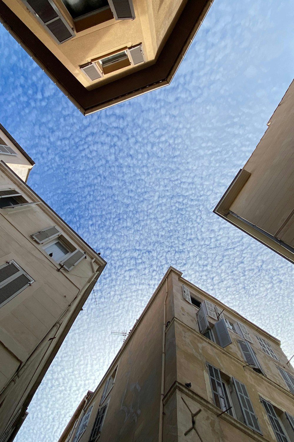 looking up at two tall buildings in a city