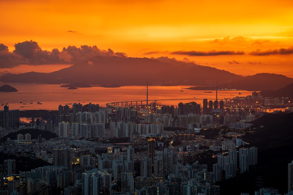 a view of a city and a body of water at sunset