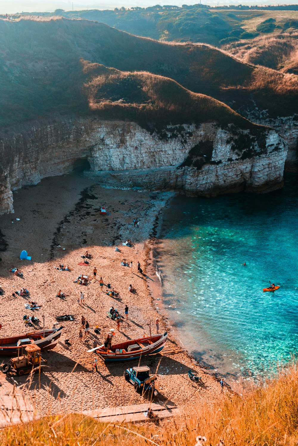 a group of boats sitting on top of a sandy beach