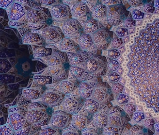 an intricate blue and purple pattern on the ceiling of a building