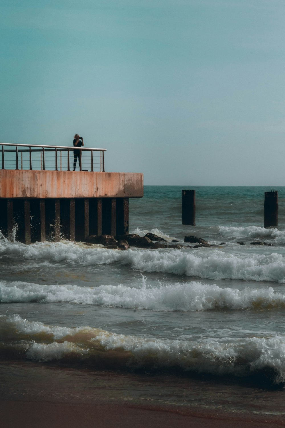 a person standing on a pier over a body of water