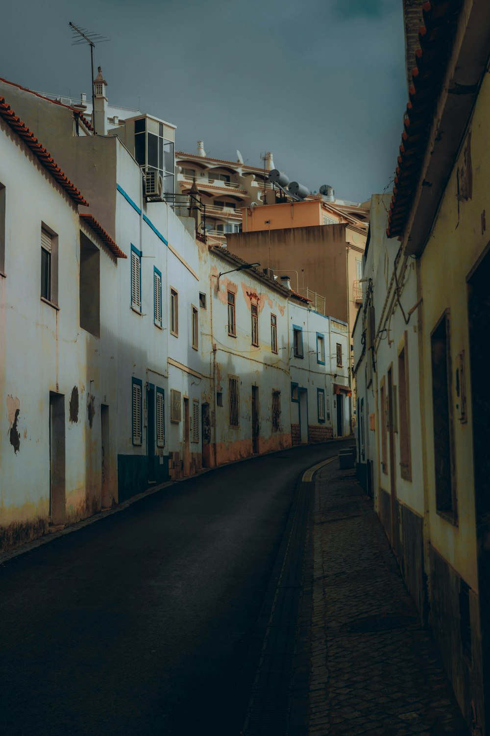 an empty street in a city with buildings on both sides