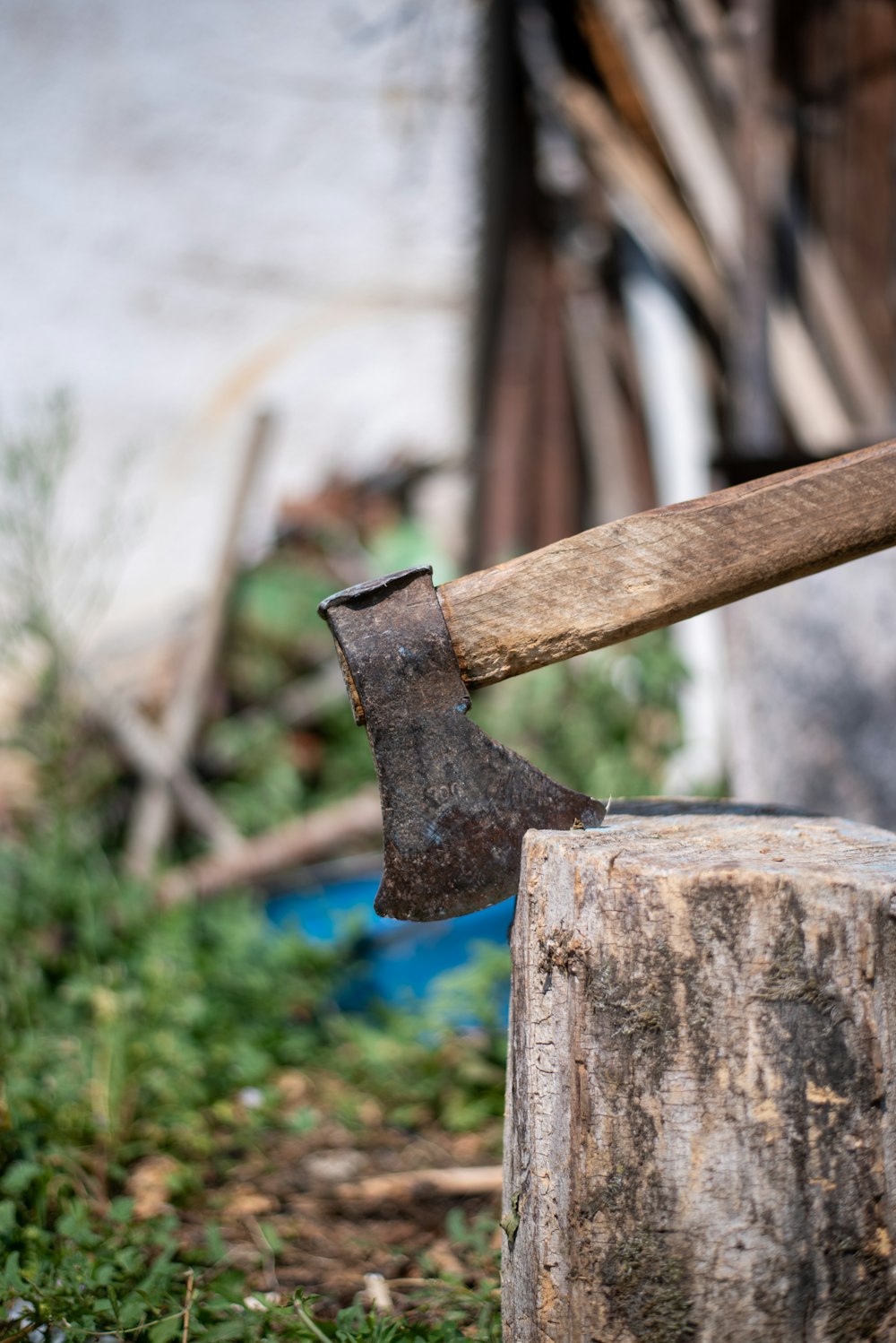 an old axe stuck in a tree stump