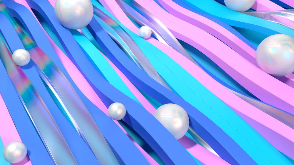 a group of white balls floating on top of blue and pink streamers