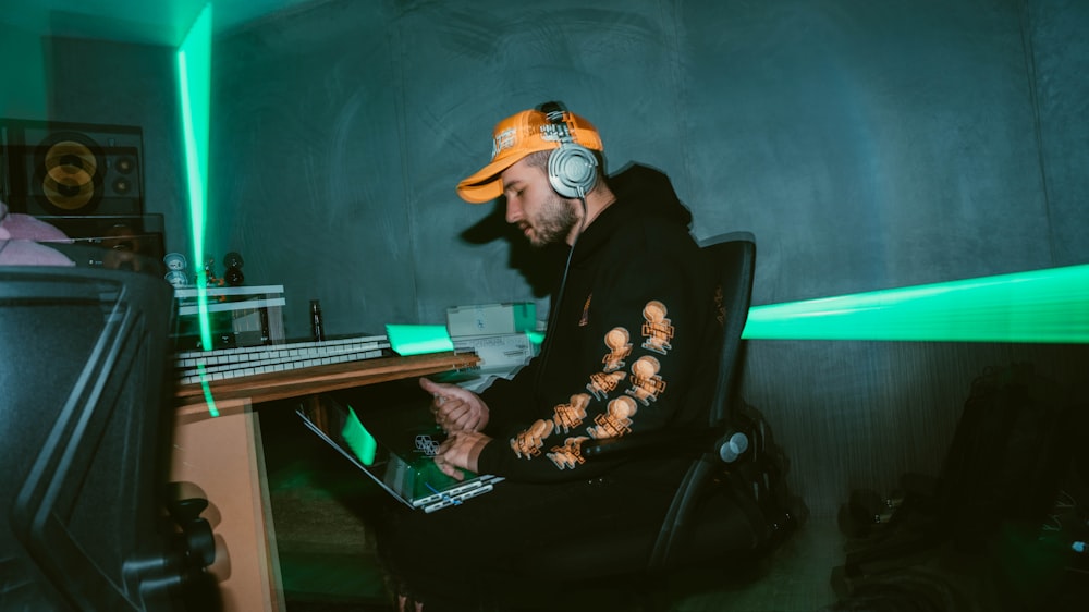 a man sitting at a desk with headphones on