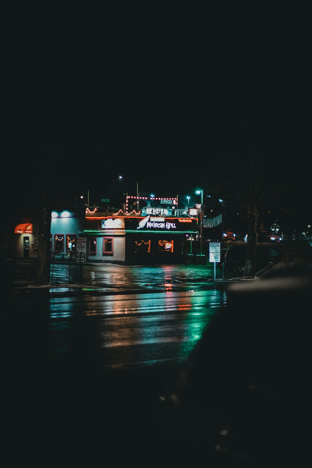 a dark city street at night with lights on