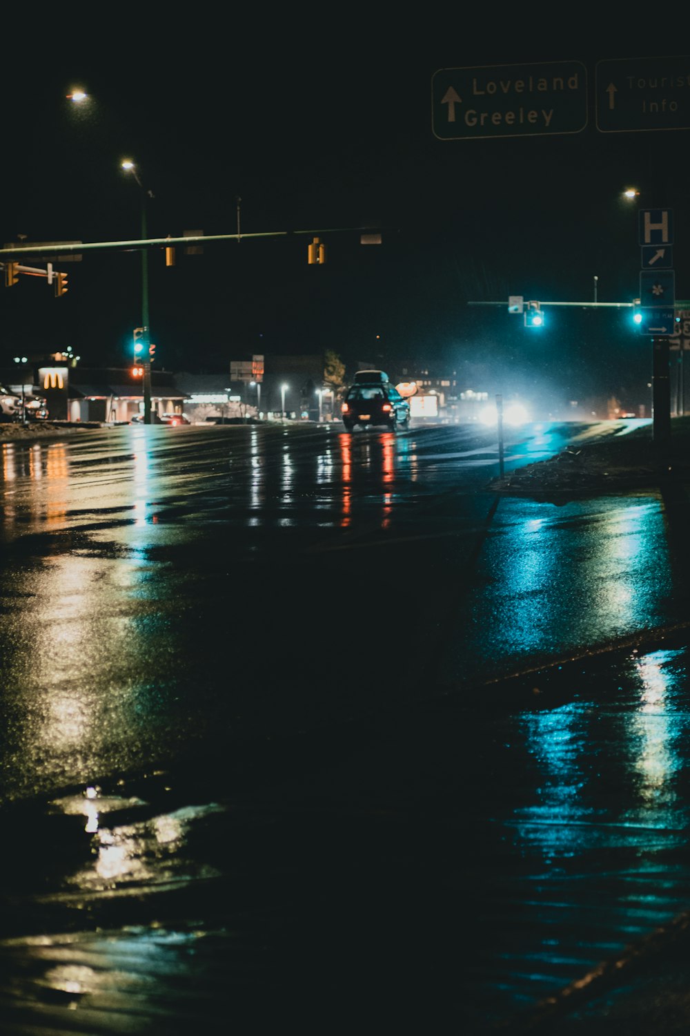 a city street at night with traffic lights