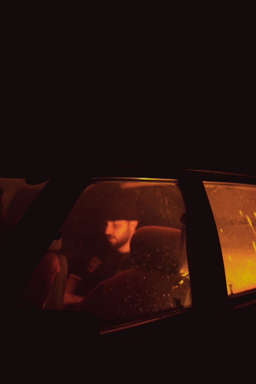 a man driving a car in the dark