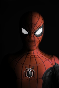a close up of a spider man with glowing eyes