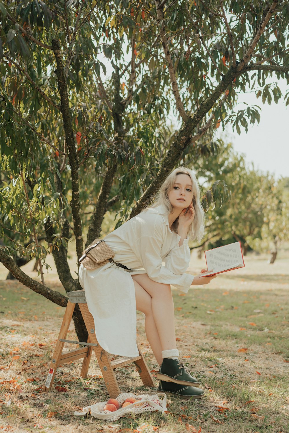 a woman sitting on a chair reading a book