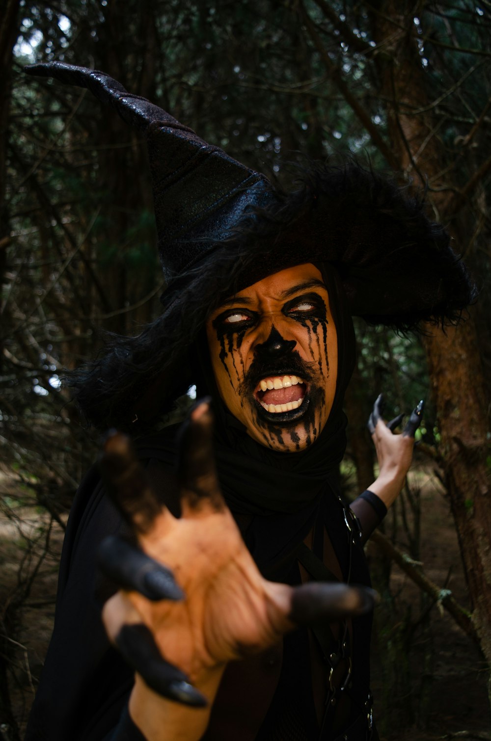 a man dressed as a scarecrow in the woods