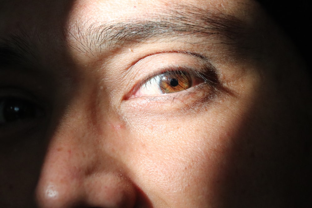 a close up of a person's eye with brown eyes