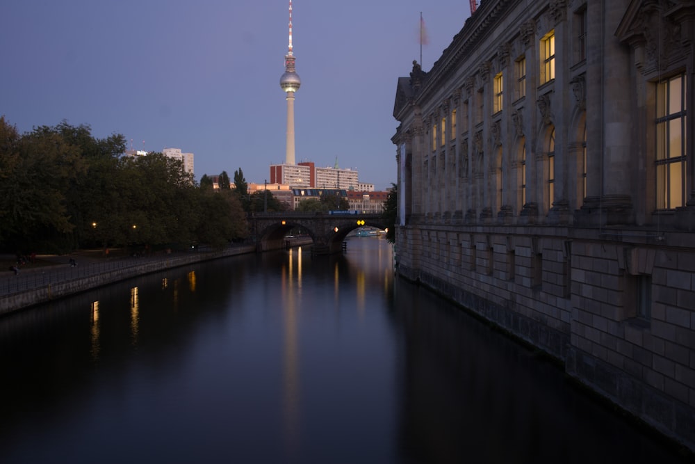 a river running through a city next to tall buildings