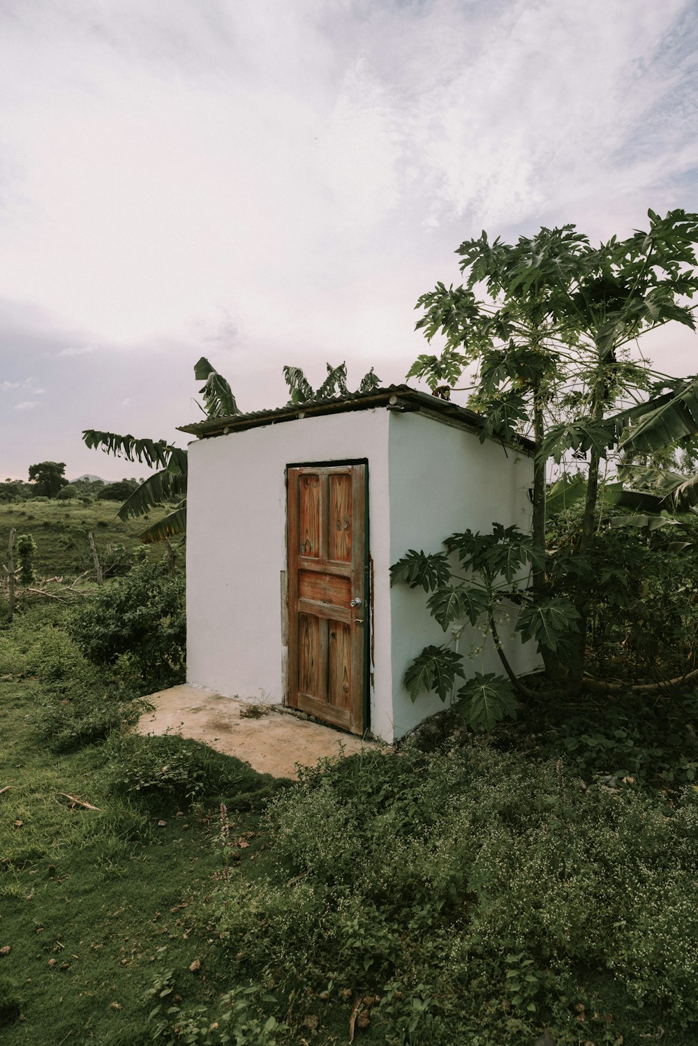 a small white building with a wooden door