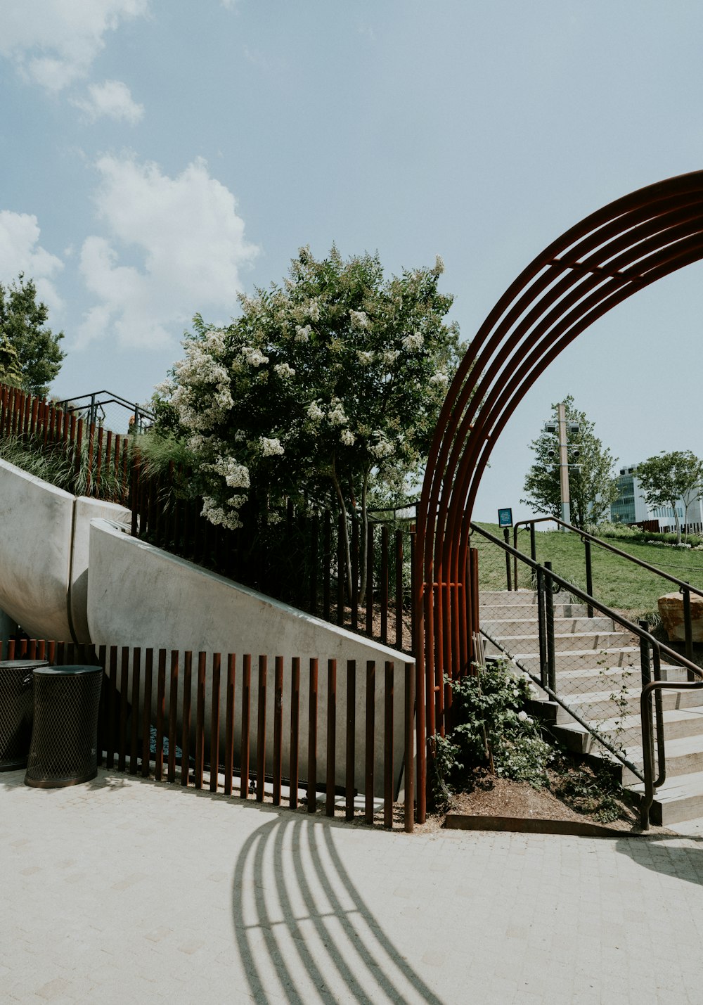 a curved metal fence next to a set of stairs