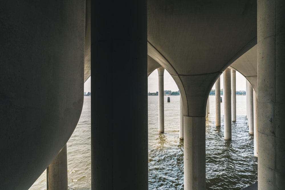 the underside of a bridge over a body of water