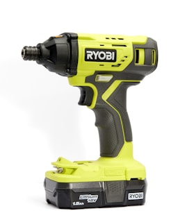A bright green and black cordless power drill with the brand name 'Ryobi' prominently displayed. The drill features textured grips and buttons for operation, and the battery section is labeled 'Lithium 18V 1.5Ah'.