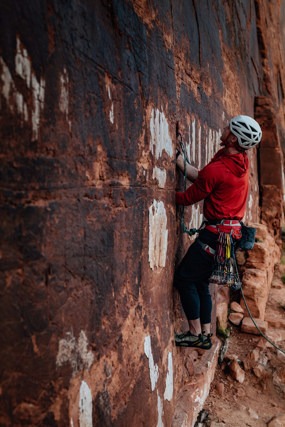 a man climbing up the side of a mountain