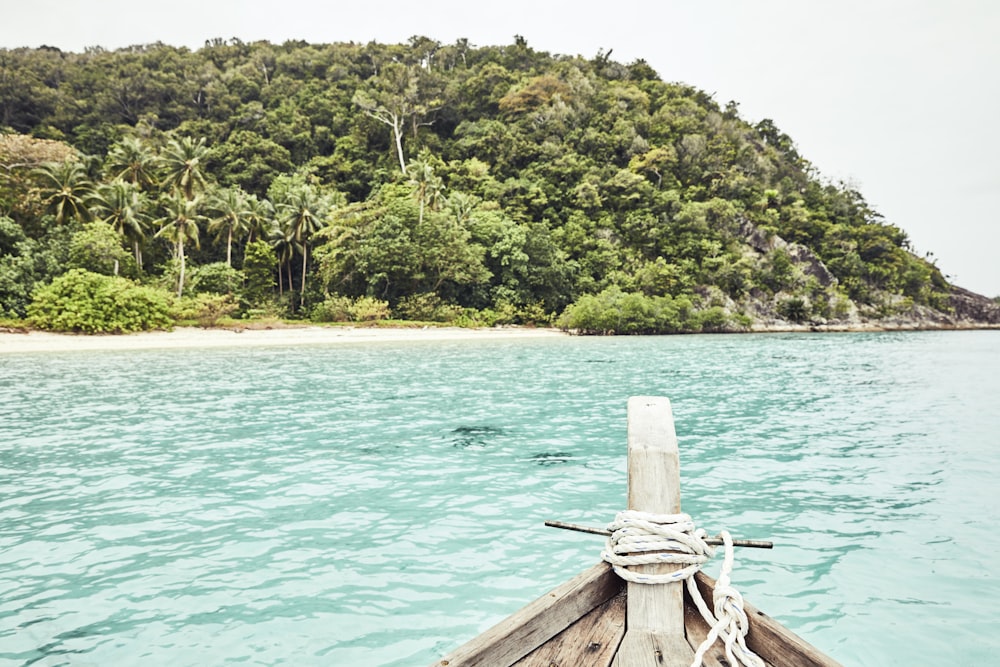 a boat in a body of water with a mountain in the background