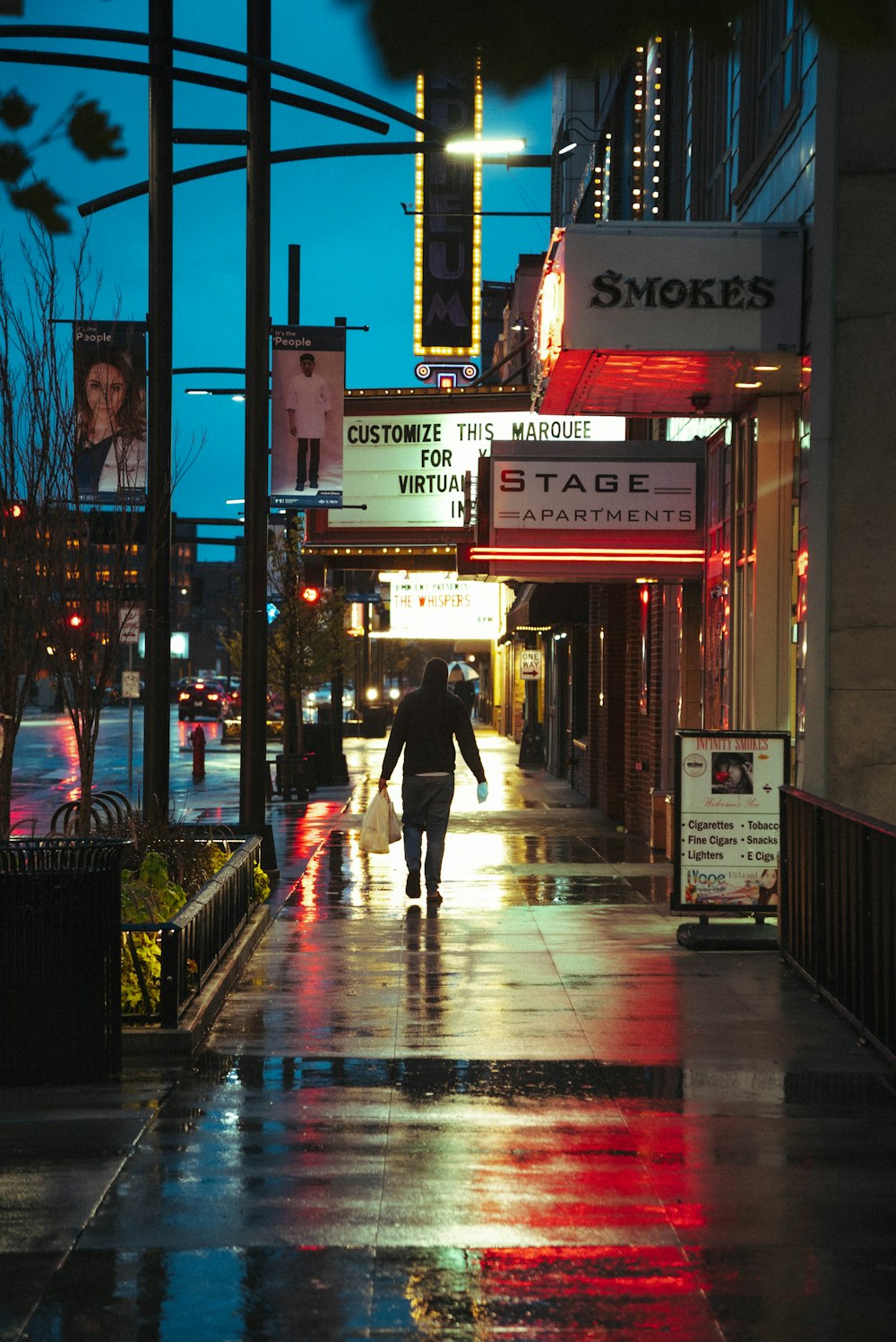 a person walking down a street in the rain