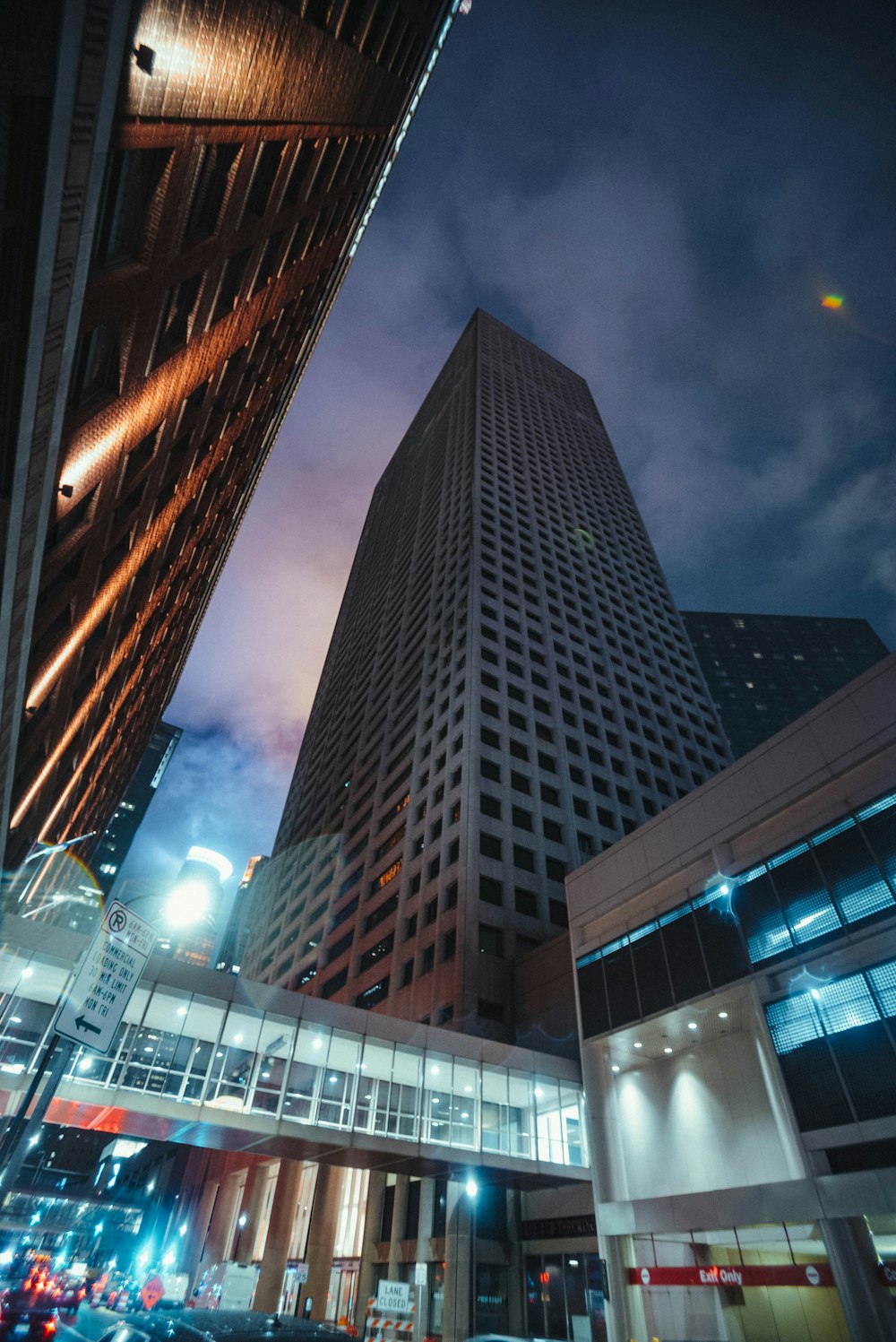 a very tall building towering over a city at night