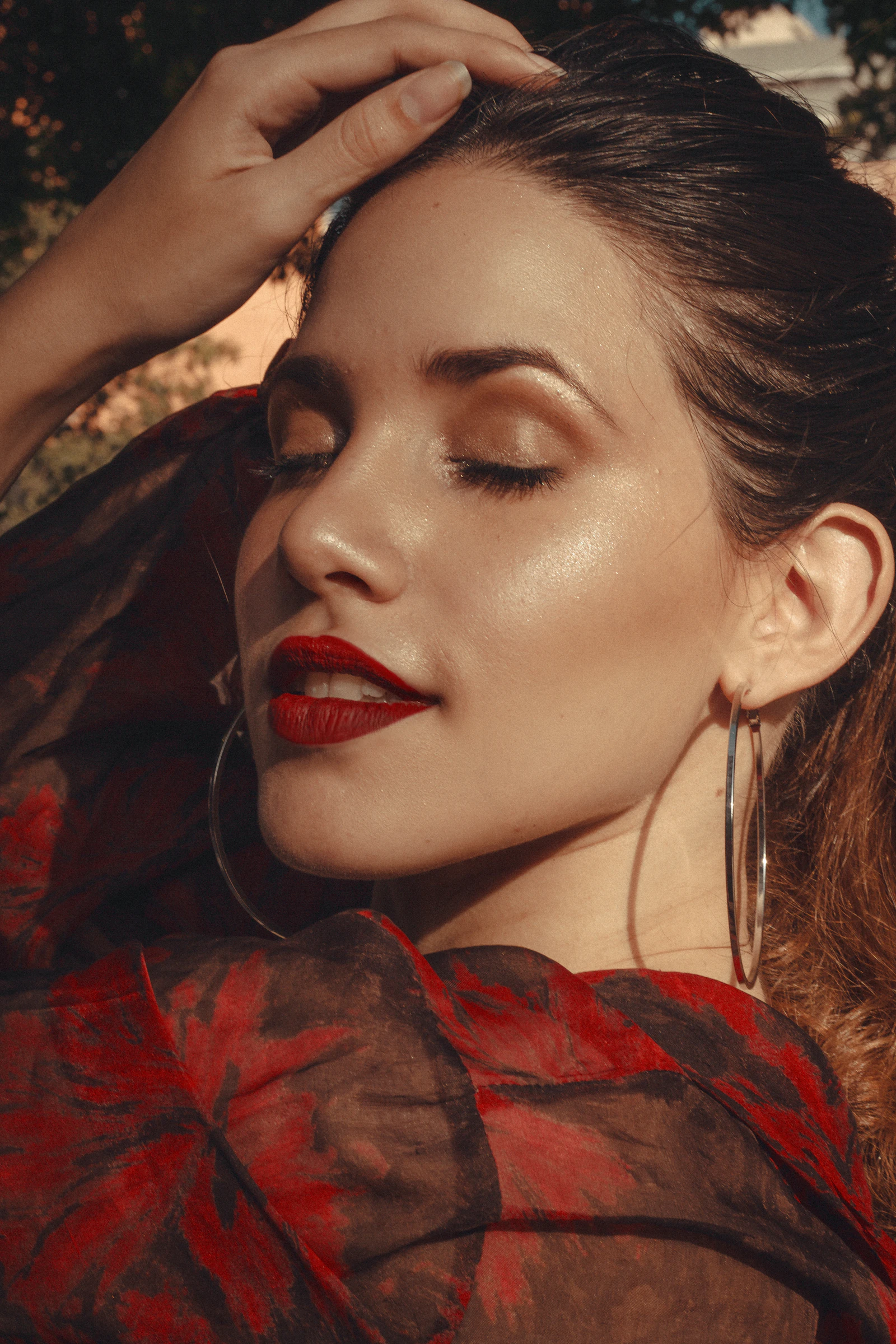 Sunlit editorial portrait, closed eyes and red lipstick